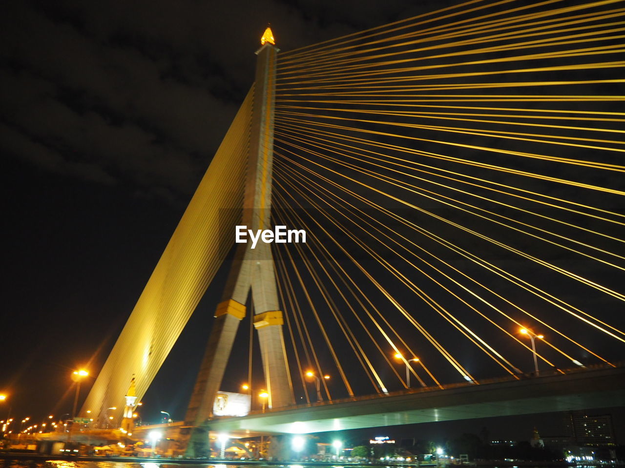 LOW ANGLE VIEW OF SUSPENSION BRIDGE AGAINST SKY AT NIGHT