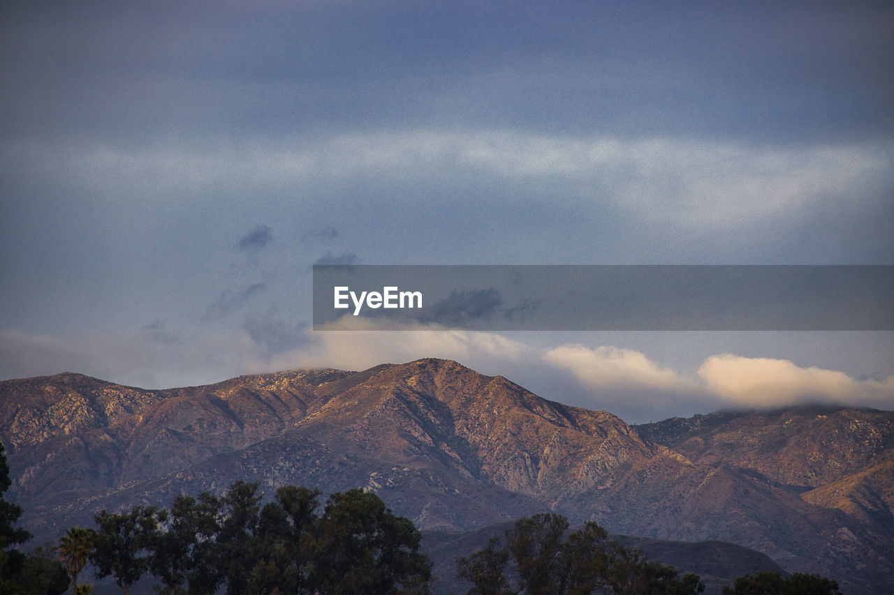 SCENIC VIEW OF MOUNTAIN AGAINST CLOUDY SKY