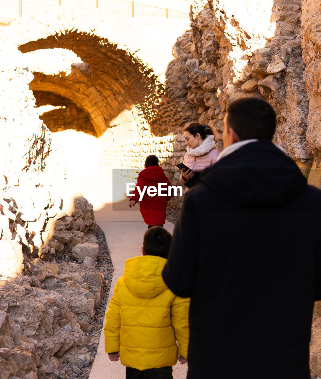 Family walk through roman ruins in tarragona