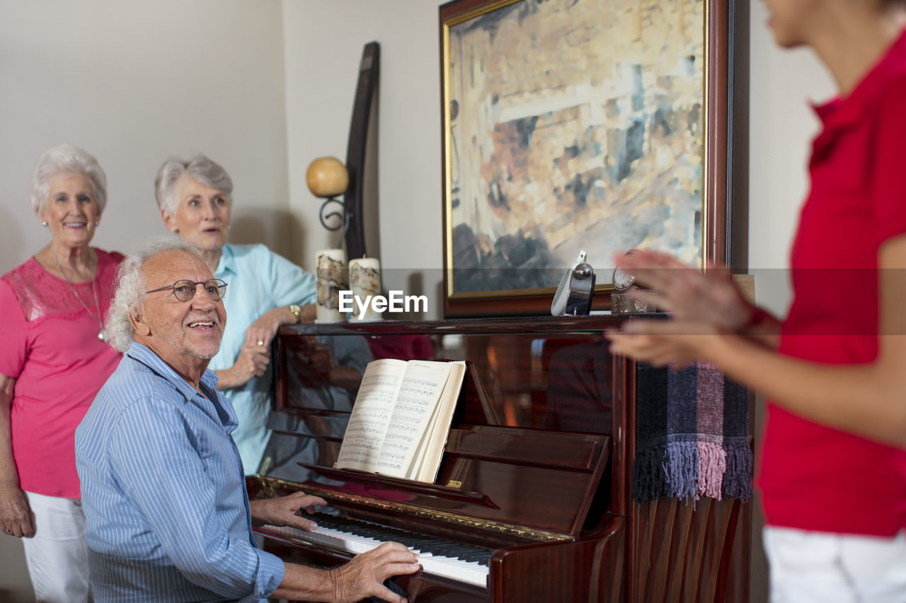 Elderly people making music in retirement home