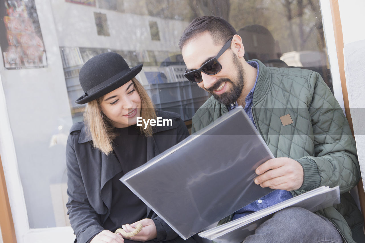 Young couple looking at records