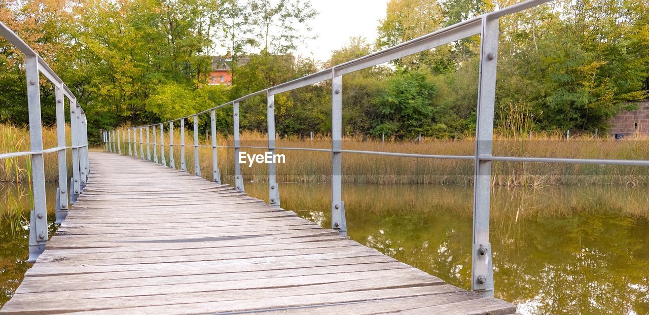 View of footbridge along plants