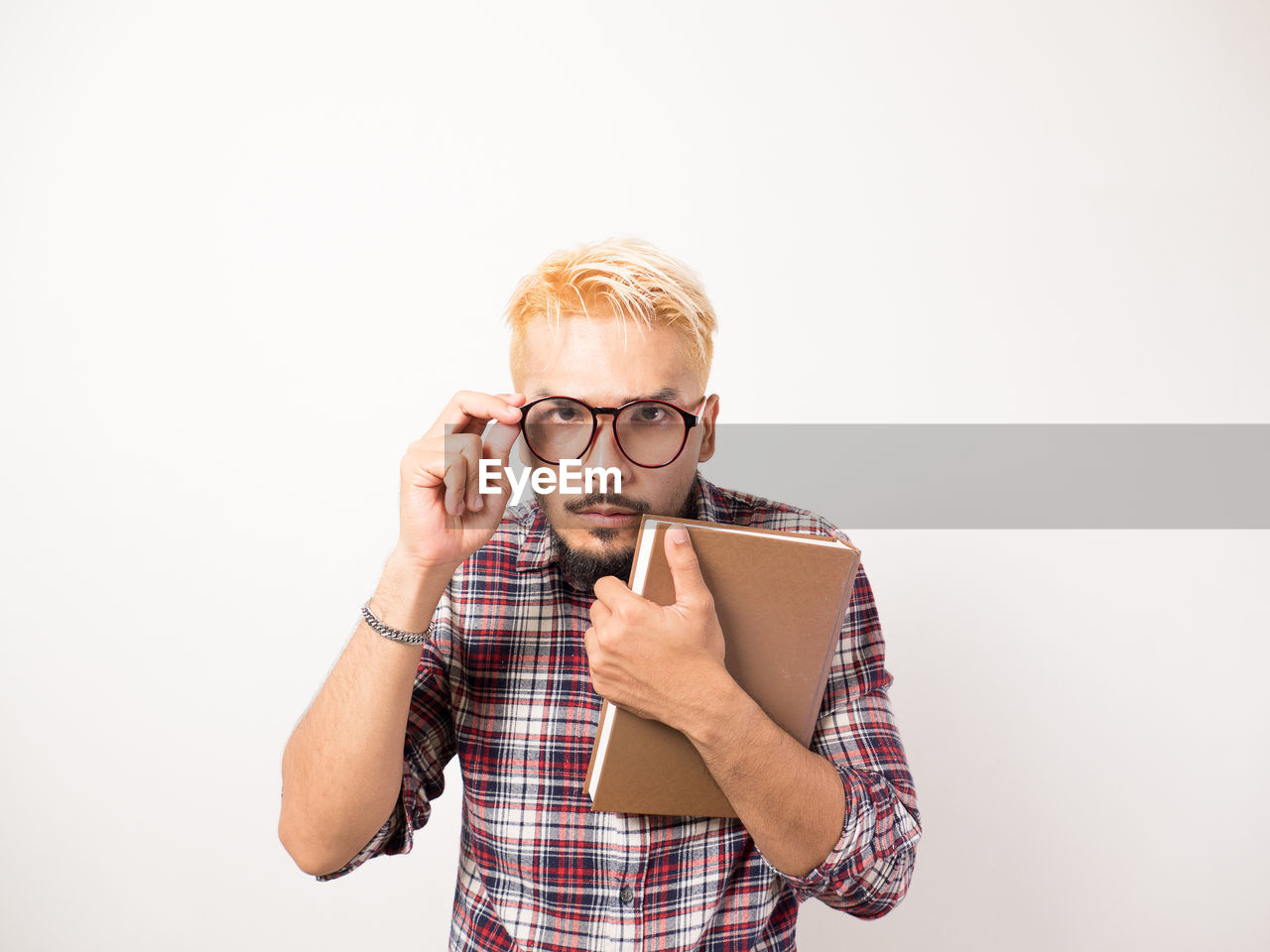 PORTRAIT OF YOUNG MAN WEARING HAT AGAINST WHITE BACKGROUND