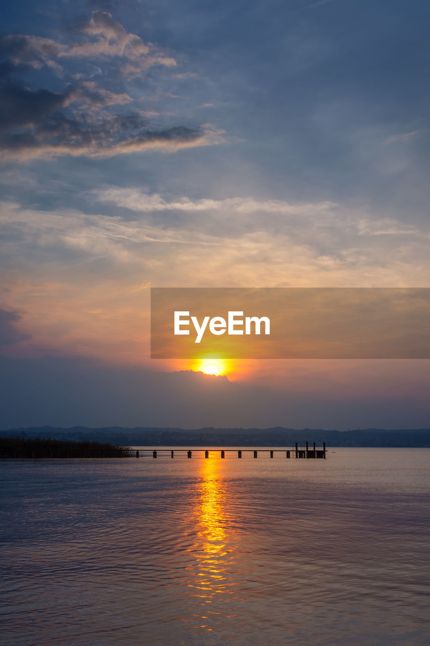 SCENIC VIEW OF SEA AGAINST ORANGE SKY DURING SUNSET