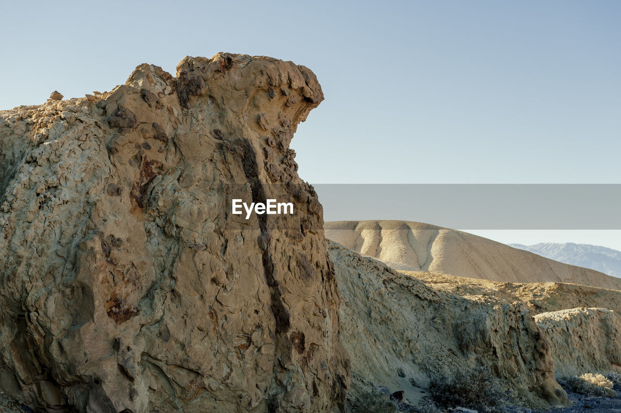 Rock formations in desert against clear sky