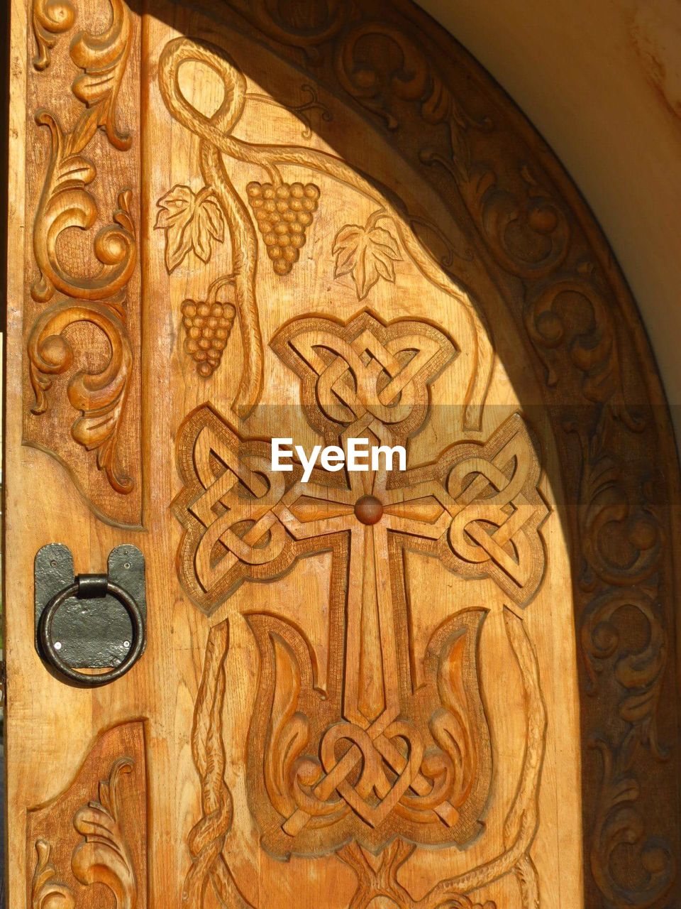 Full frame shot of wooden door with cravings at church