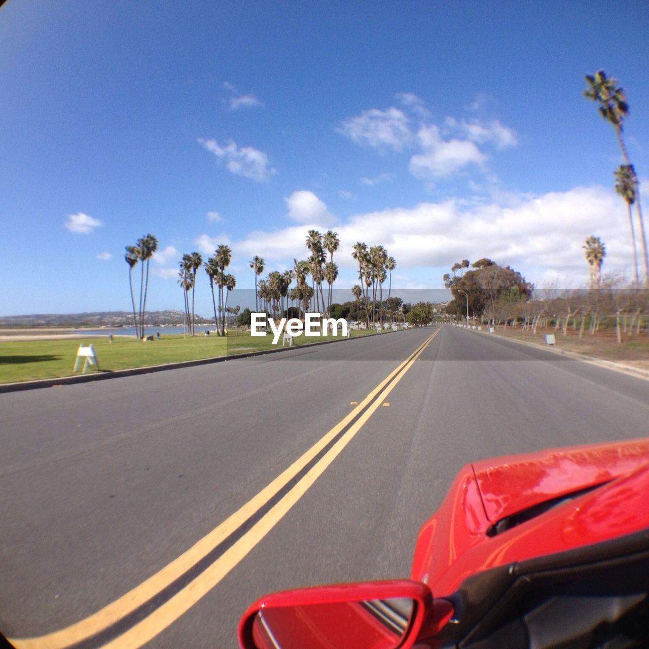 Cropped image of car on road against sky