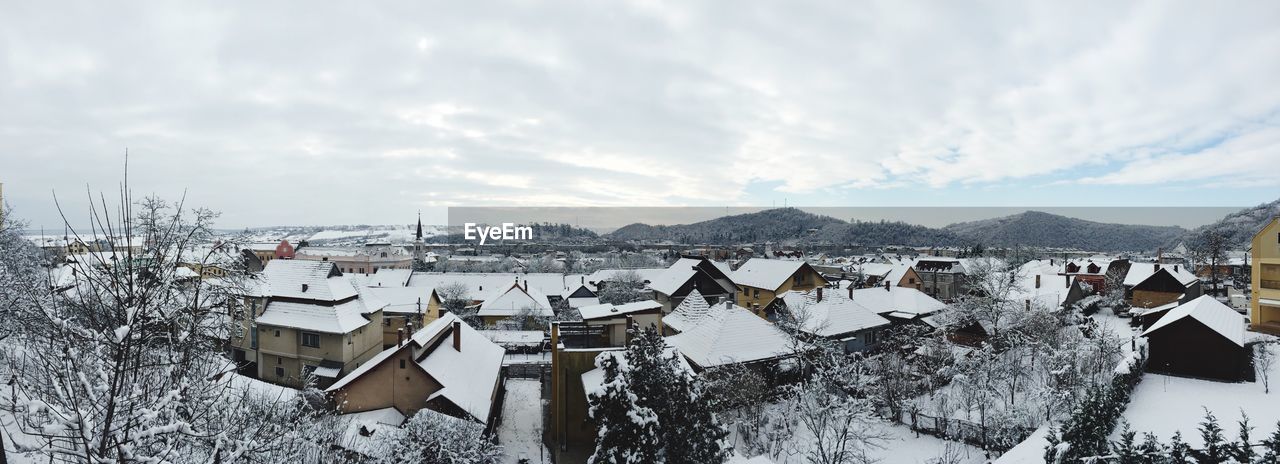 Panoramic view of buildings against sky during winter