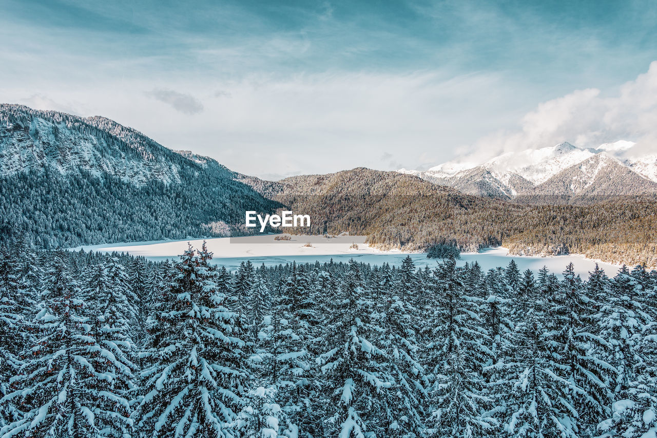 Snowy mountains and trees in the alps. view of the lake eibsee. germany.