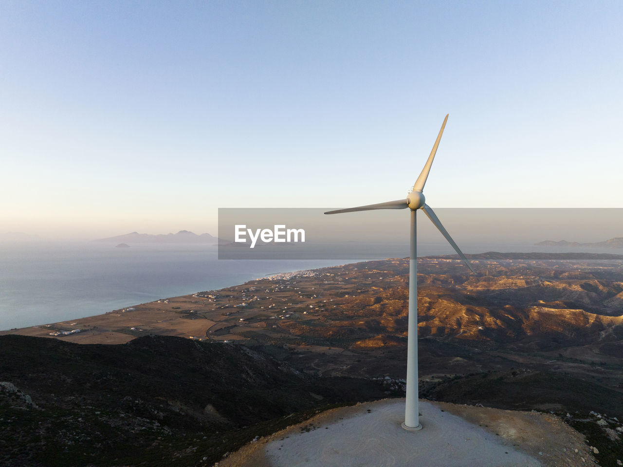 Greece, aegean, kos, hilltop wind turbine at dawn