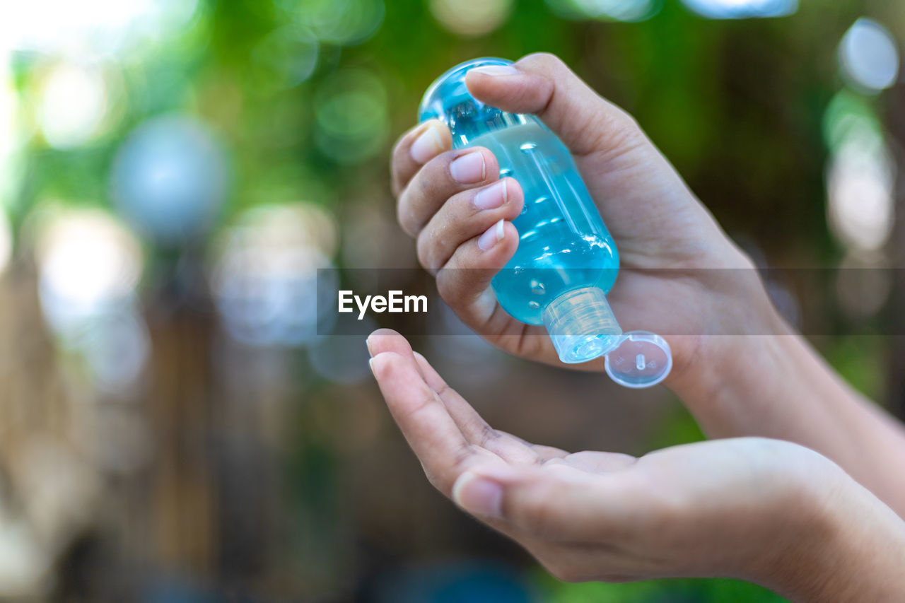 Close-up of person hand holding bottle