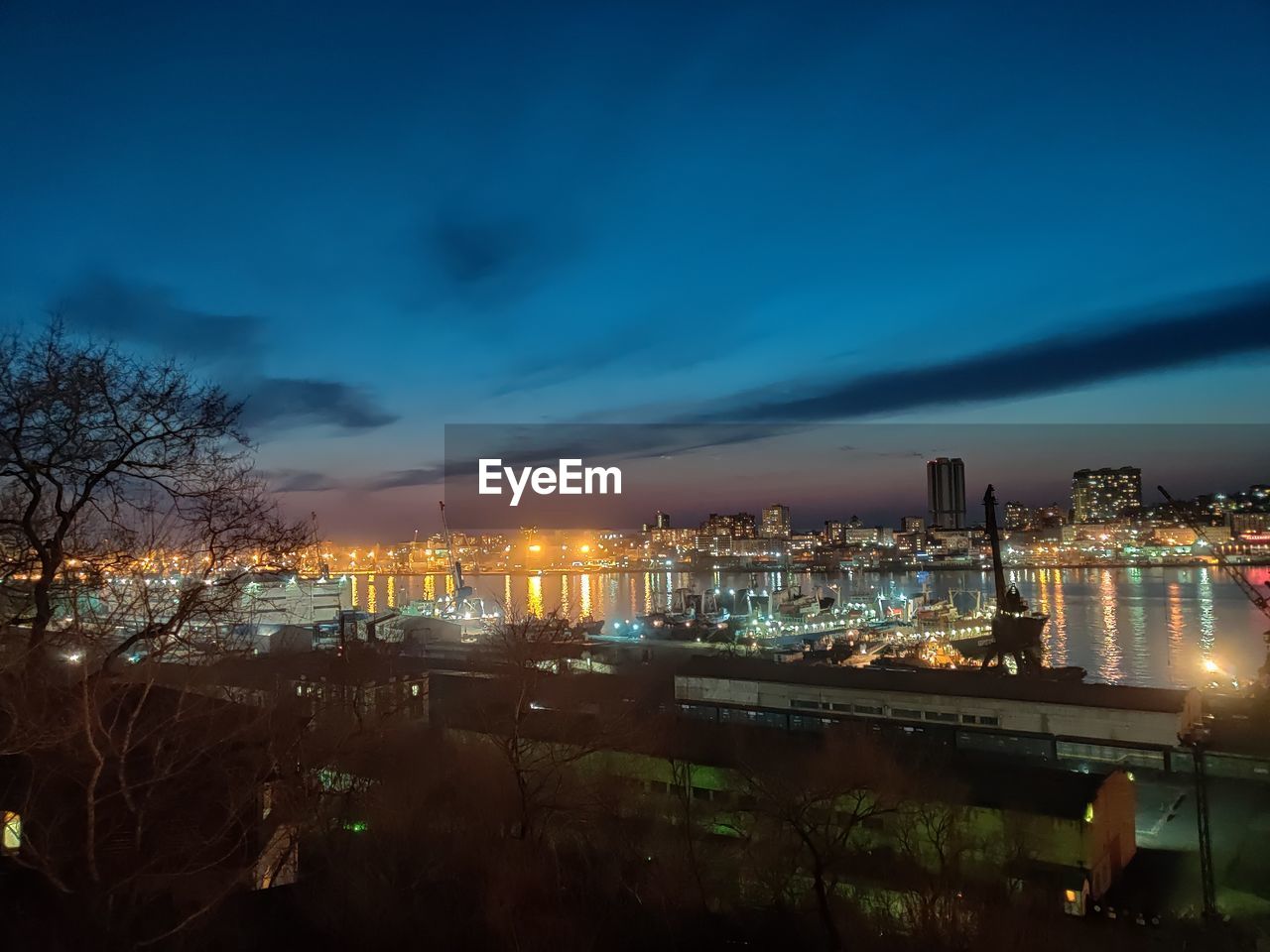 HIGH ANGLE VIEW OF ILLUMINATED CITY AT NIGHT