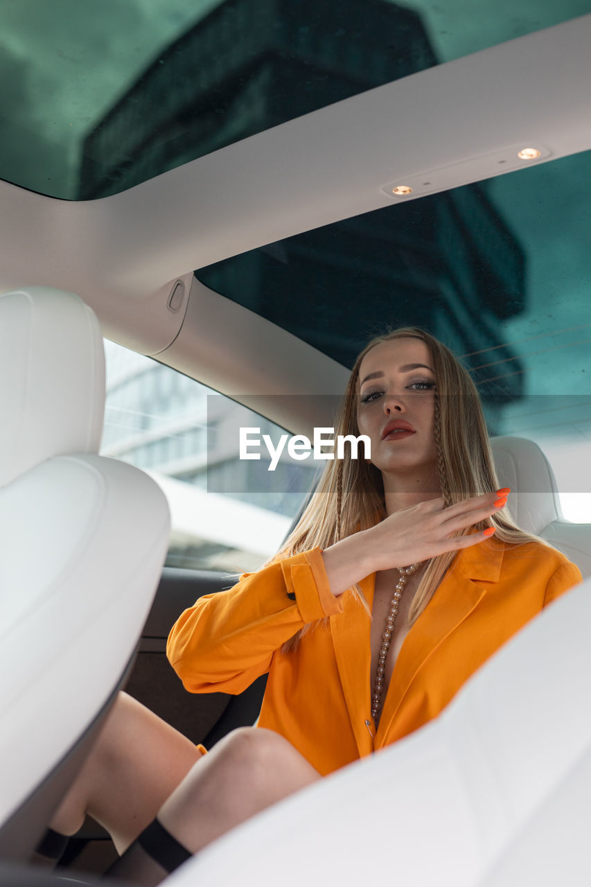 Portrait of young woman in car