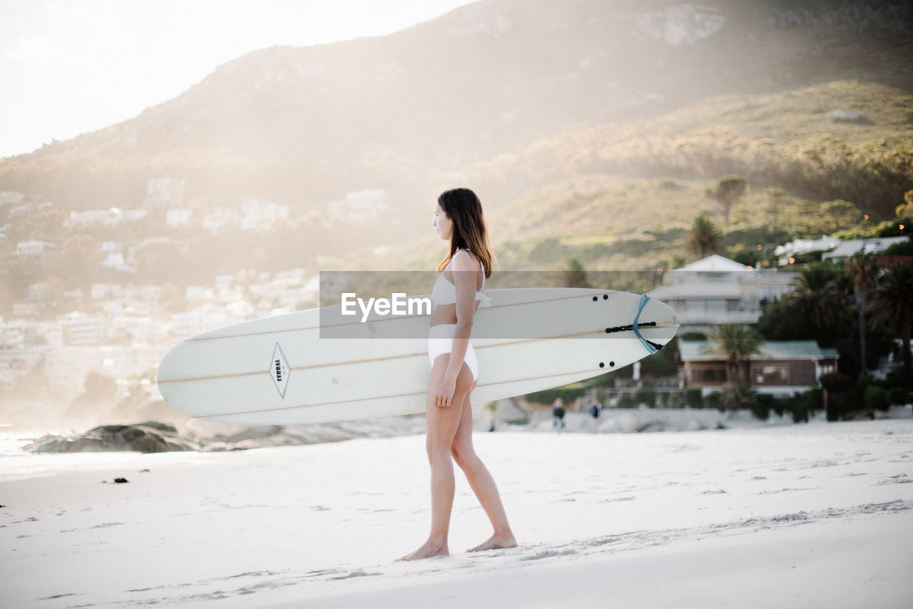 WOMAN STANDING ON BEACH