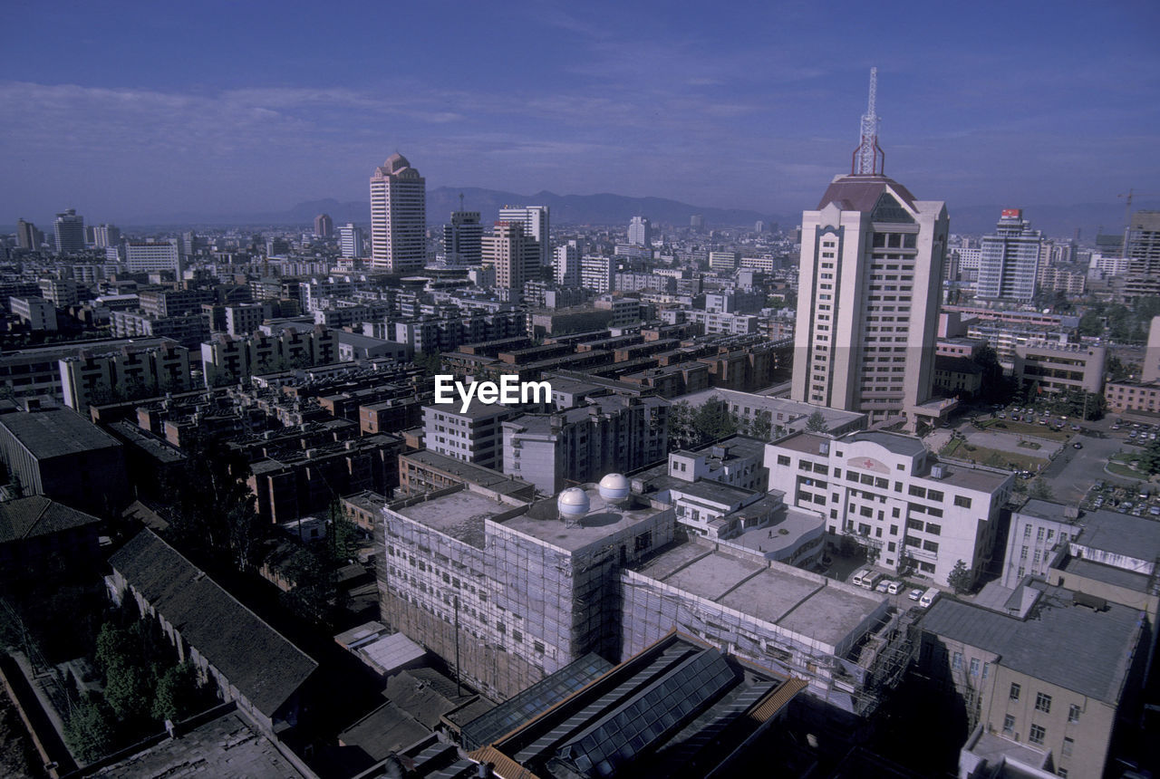 high angle view of buildings in city against sky