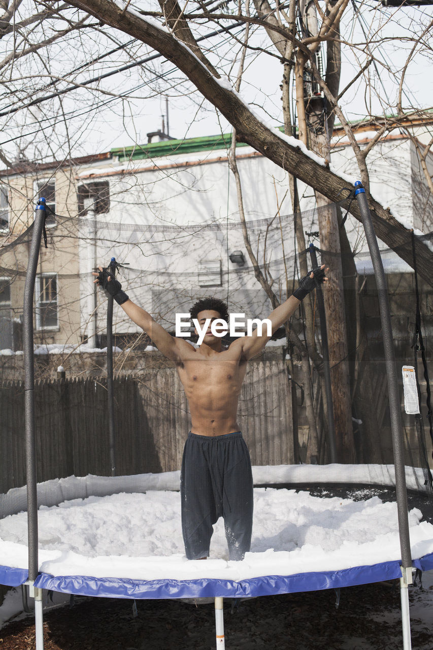 Young male boxer posing in the snow