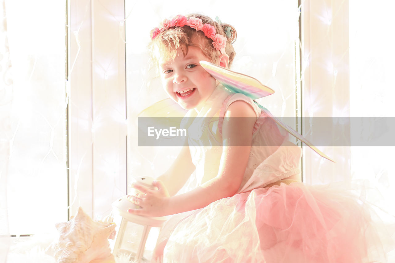Portrait of cute girl in costume smiling at home