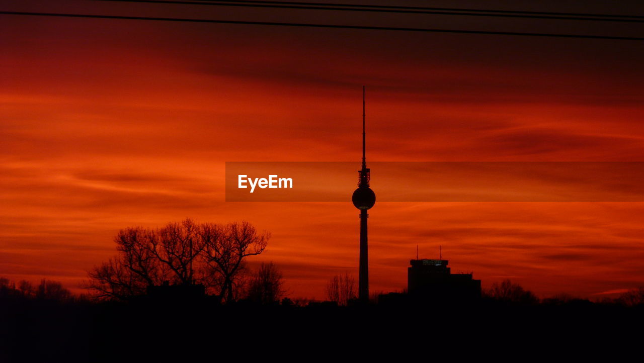 SILHOUETTE OF COMMUNICATIONS TOWER DURING SUNSET