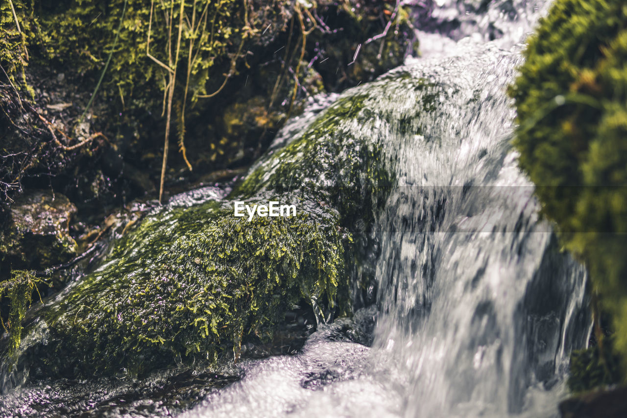 STREAM FLOWING THROUGH ROCKS