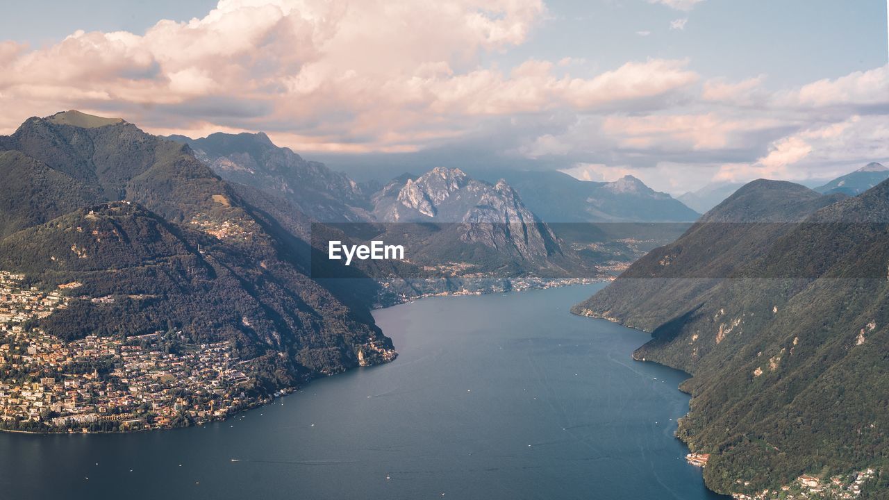 Aerial view of lake amidst mountains against sky