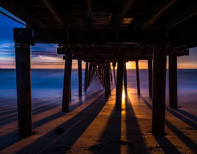 PIER ON SEA AT SUNSET