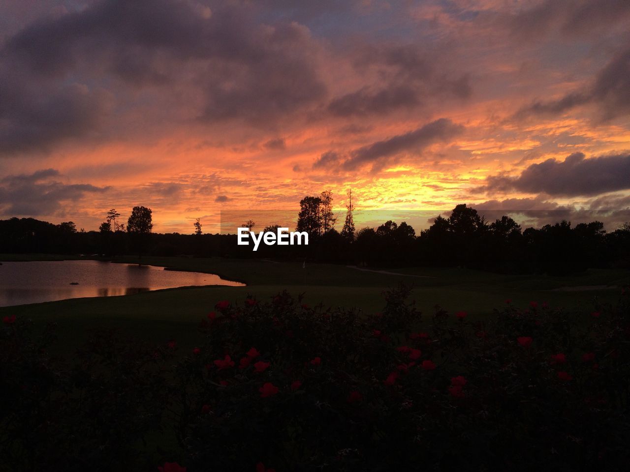 SCENIC VIEW OF SUNSET OVER CALM LAKE