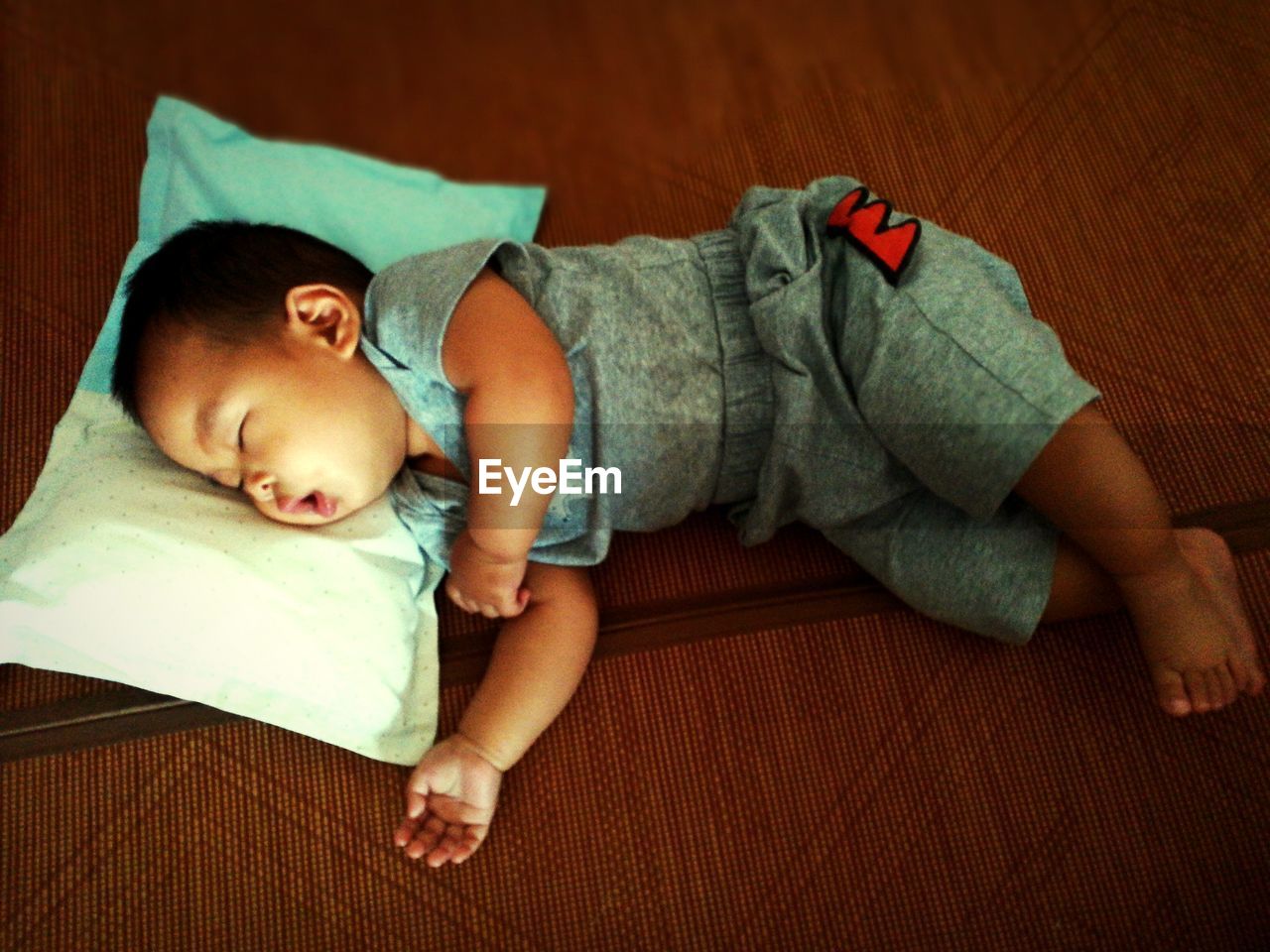 High angle view of baby boy sleeping on bed at home