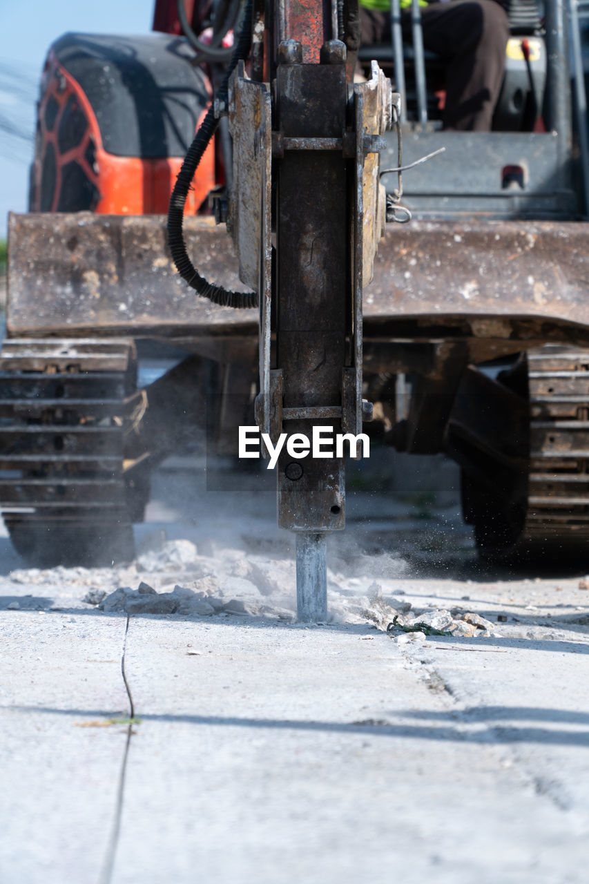 Construction machinery digging on road