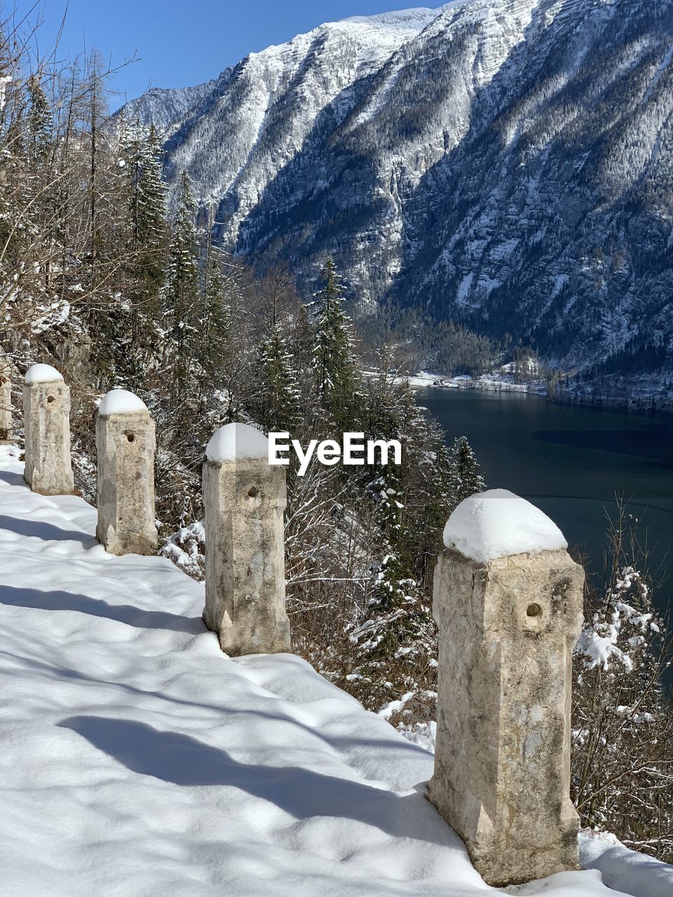 Scenic view of snow covered field against mountain in hallstatt austria 