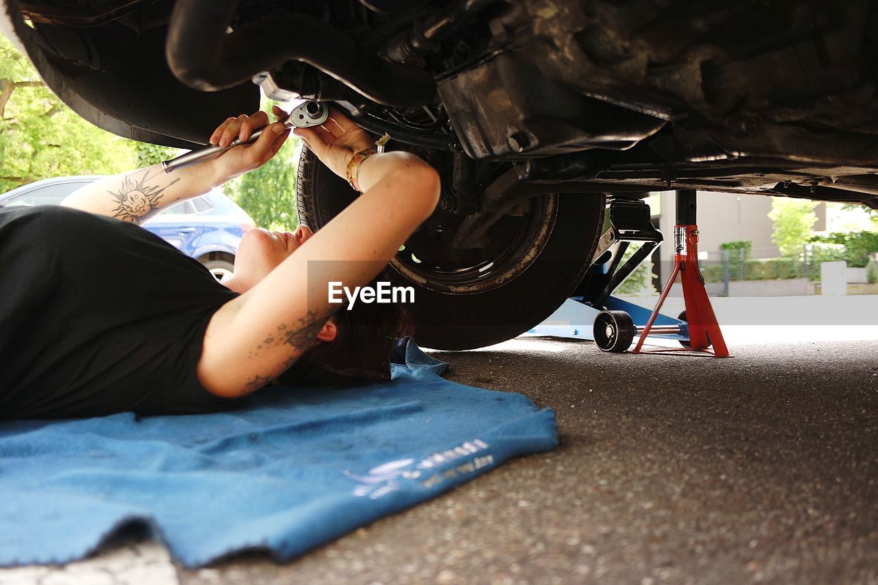 Woman repairing car wheel