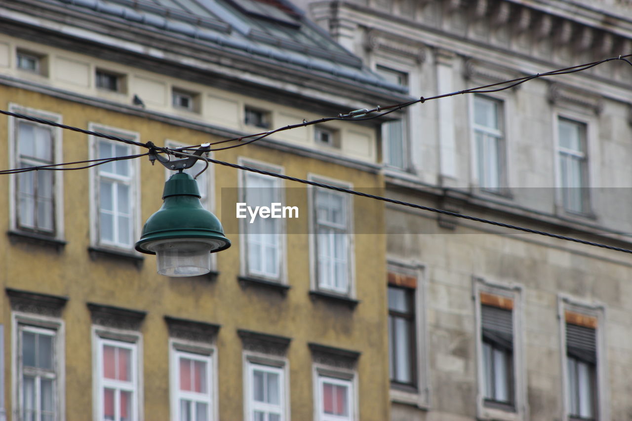 Low angle view of lantern hanging against sky