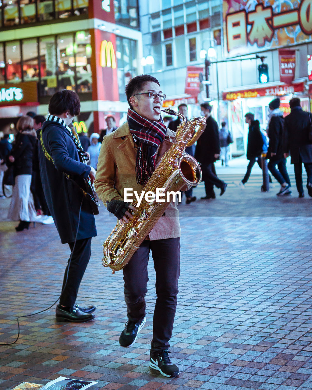 PEOPLE PLAYING ON STREET IN CITY DURING FESTIVAL