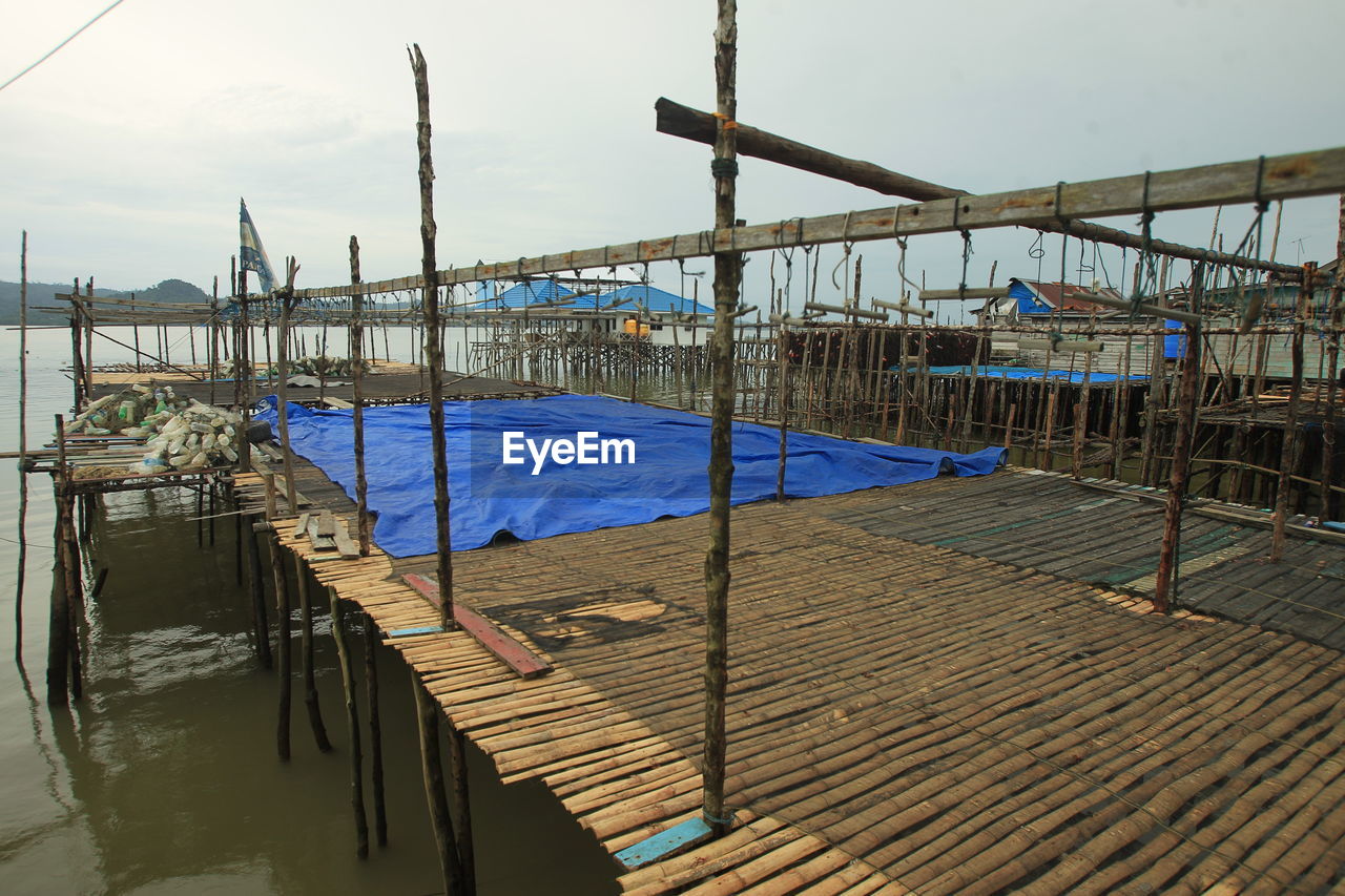 WOODEN PIER OVER SEA AGAINST SKY