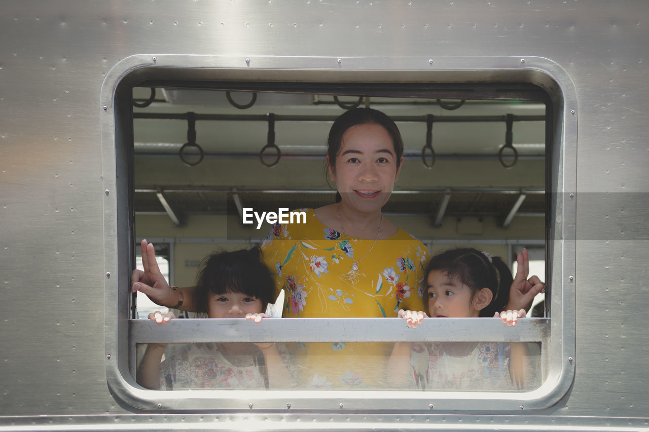 Two little child girls and her mother in the train