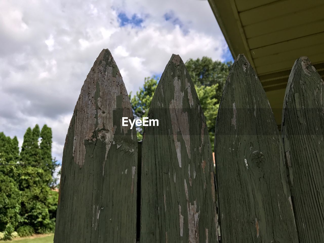 LOW ANGLE VIEW OF PANORAMIC SHOT OF WOODEN POST AGAINST SKY