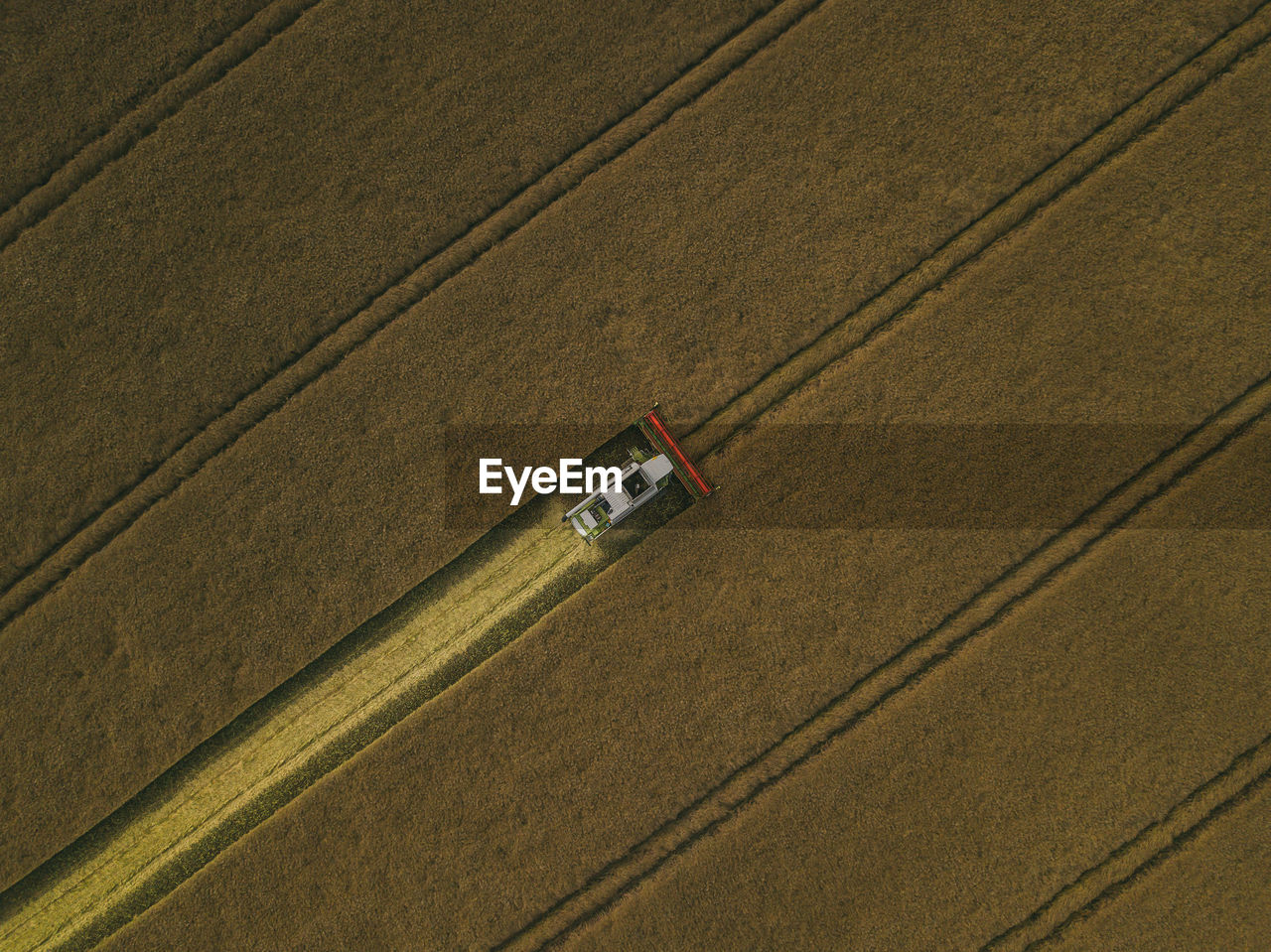 Aerial view of machinery working in agricultural field