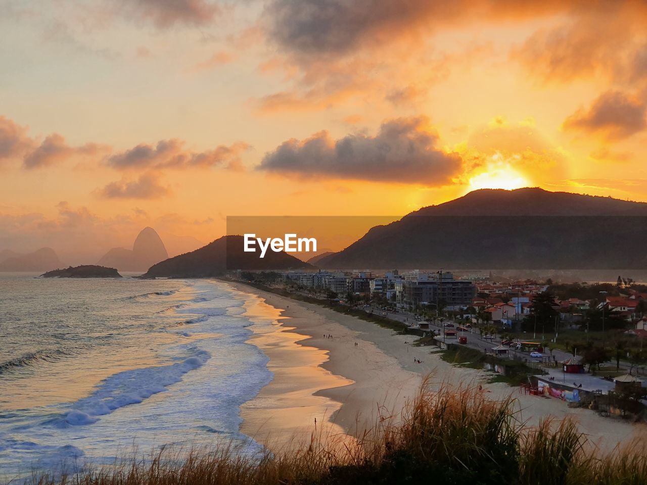 Scenic view of beach against sky during sunset