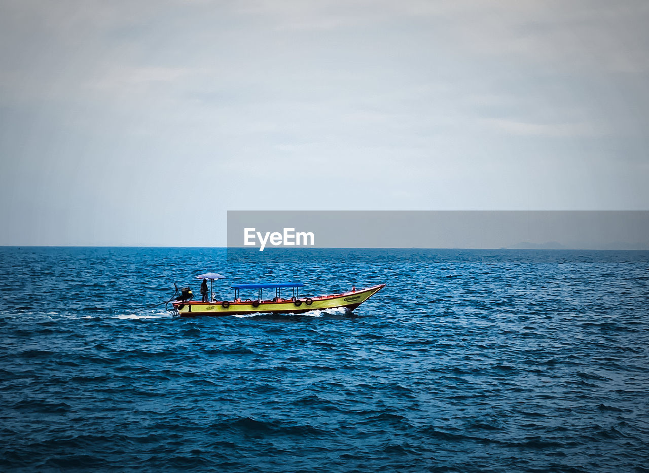 water, nautical vessel, sea, transportation, sky, horizon over water, mode of transportation, horizon, nature, ocean, vehicle, beauty in nature, boat, scenics - nature, cloud, day, waterfront, travel, boating, men, outdoors, tranquility, bay, sailing, blue, two people, tranquil scene, motion, watercraft, adult, rippled, leisure activity, ship, coast, wave, holiday, shore