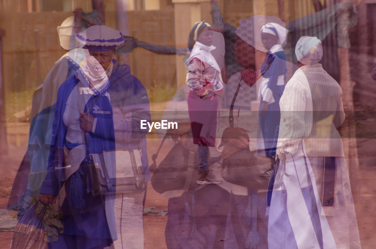 group of people, adult, clothing, traditional clothing, person, men, architecture, women, togetherness, costume, three quarter length, teamwork, standing, small group of people, cooperation, occupation