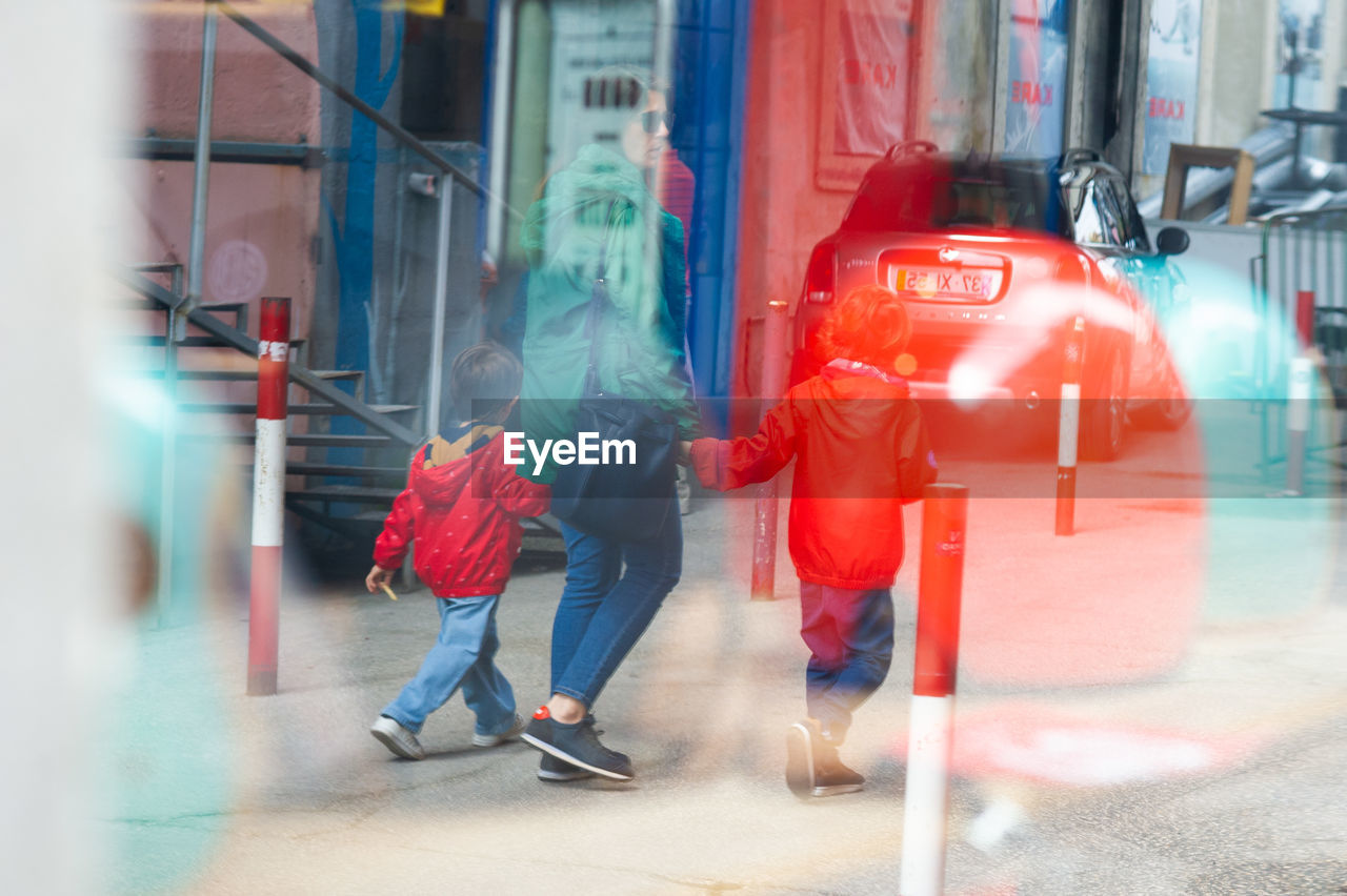 GROUP OF PEOPLE WALKING ON STREET