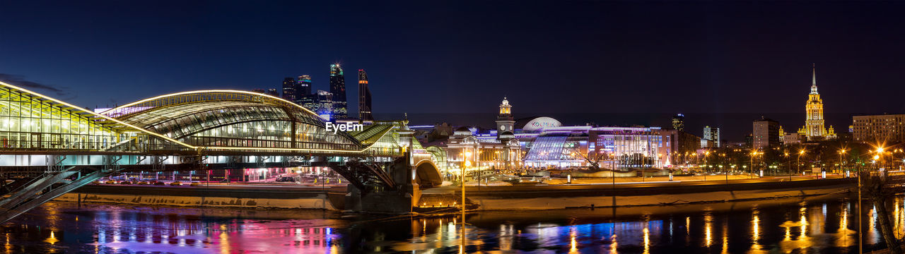 Night winter panorama of the moskva river embankment and pedestrian bridge
