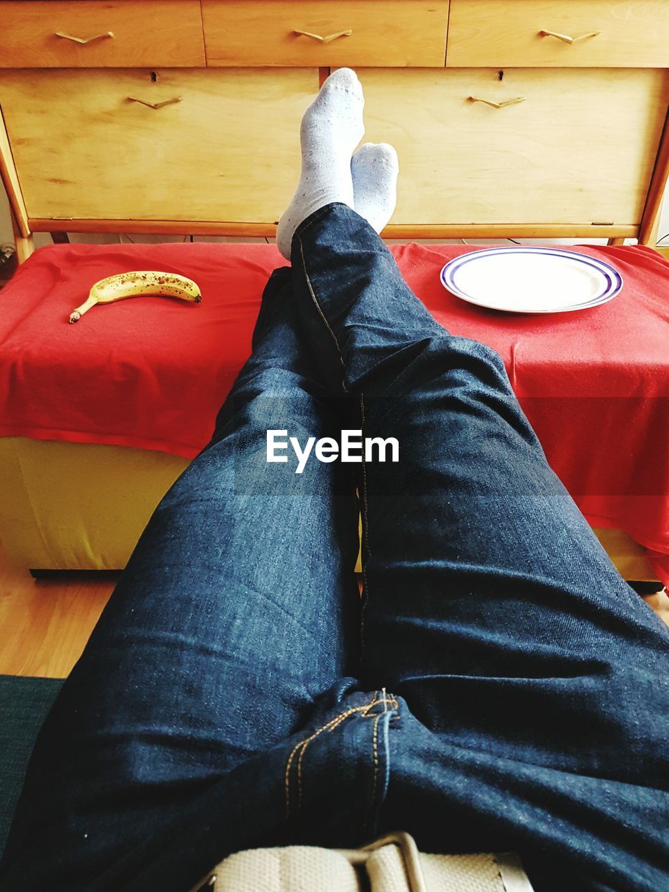LOW SECTION OF WOMAN SITTING ON FLOOR