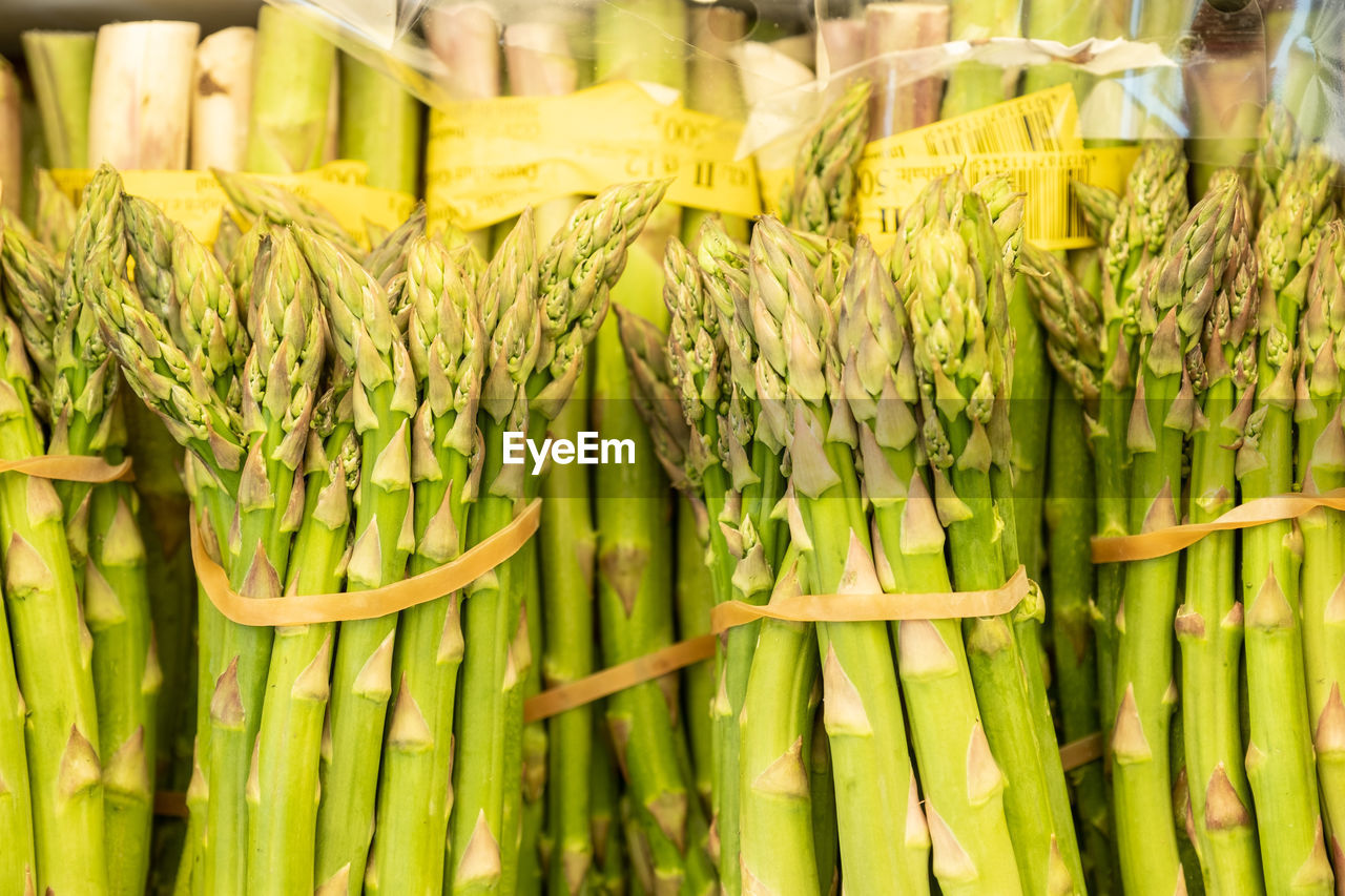 Bunches of green asparagus on market stall