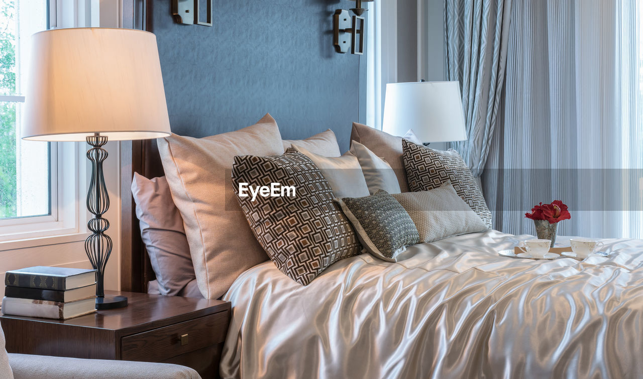 CLOSE-UP OF ELECTRIC LAMP ON BED