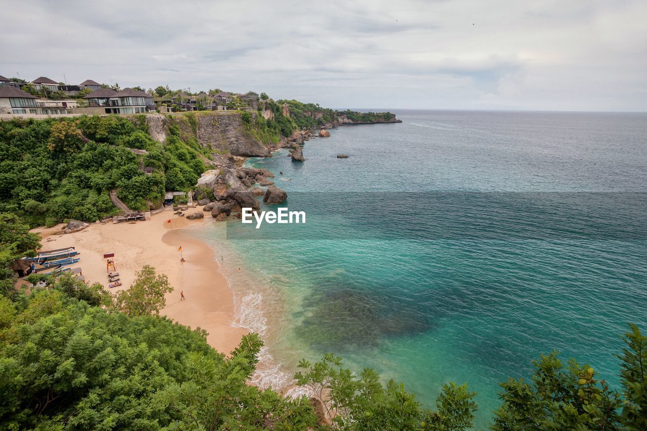 High angle view of sea by city against sky