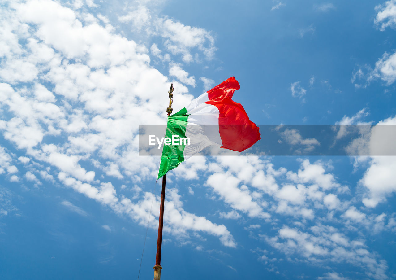Low angle view of italian flag against blue sky