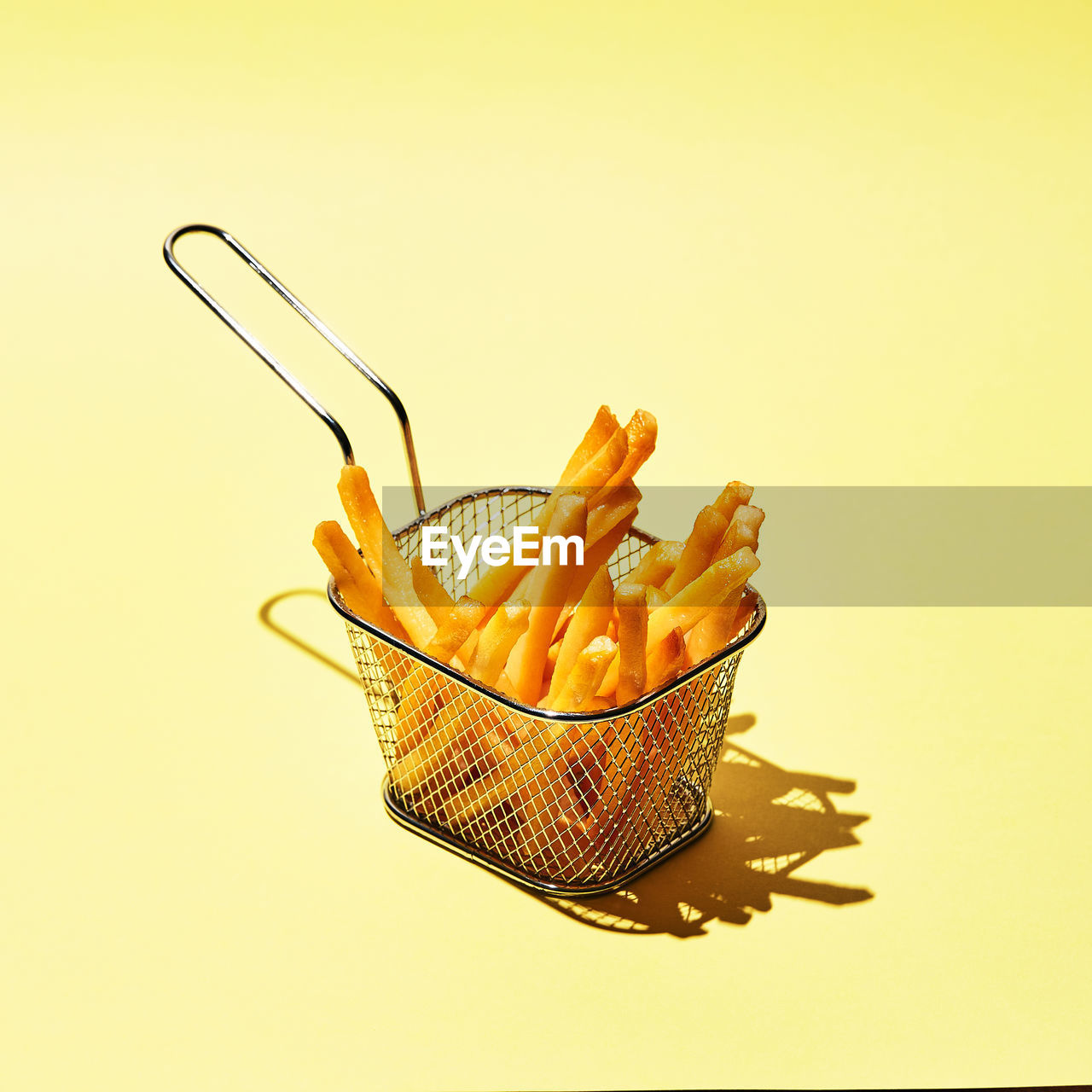 CLOSE-UP OF DRIED FRUITS ON YELLOW BACKGROUND