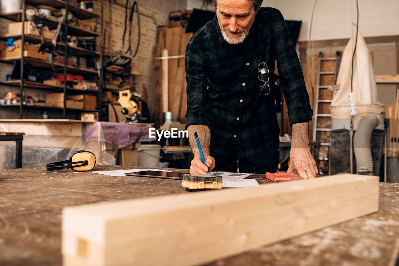 Carpenter working in factory