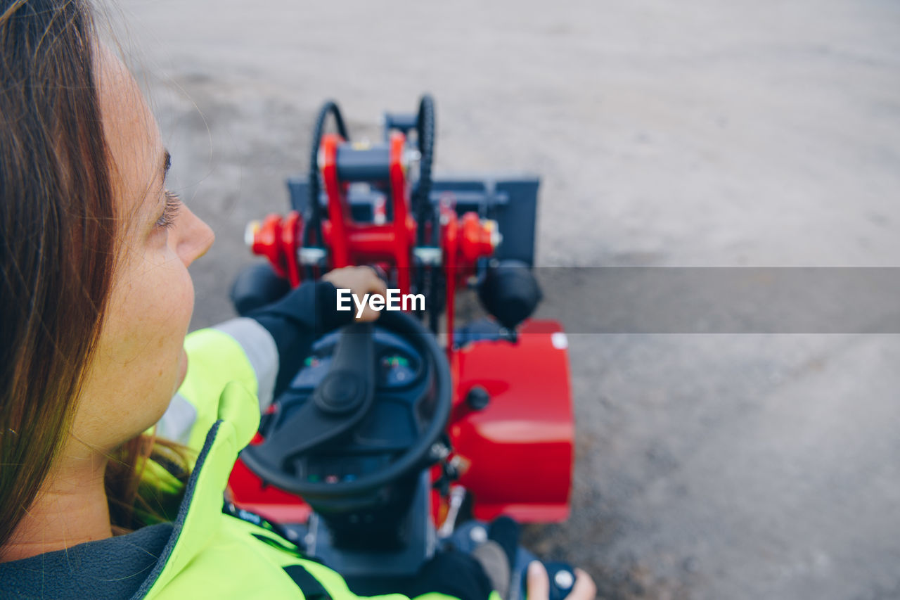 High angle view of woman with machinery at construction site