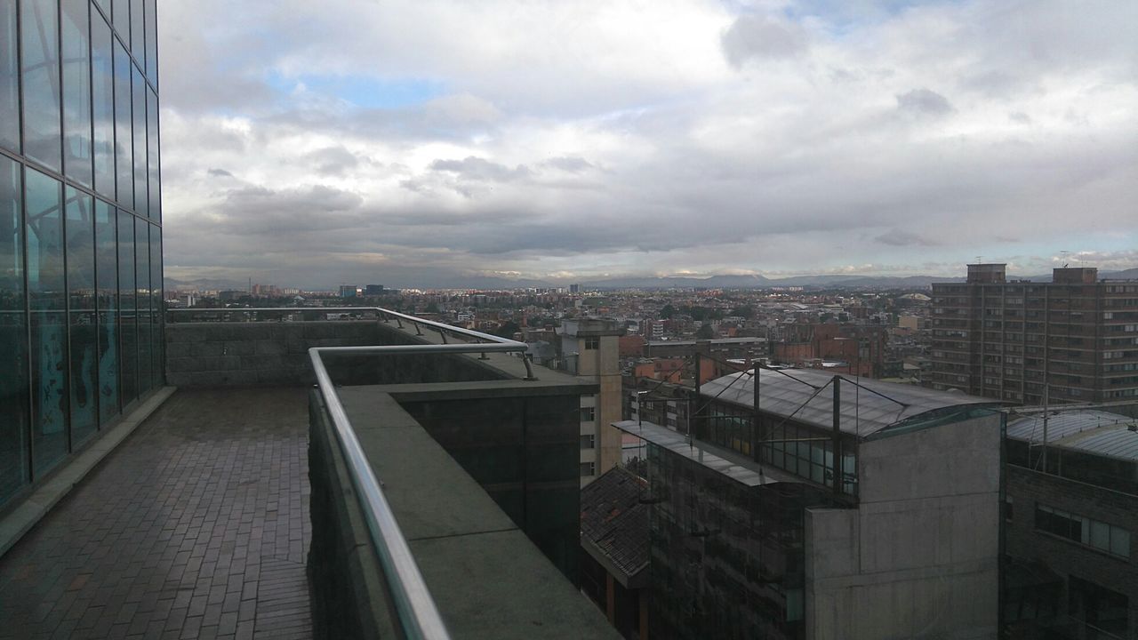 VIEW OF CITYSCAPE AGAINST CLOUDY SKY